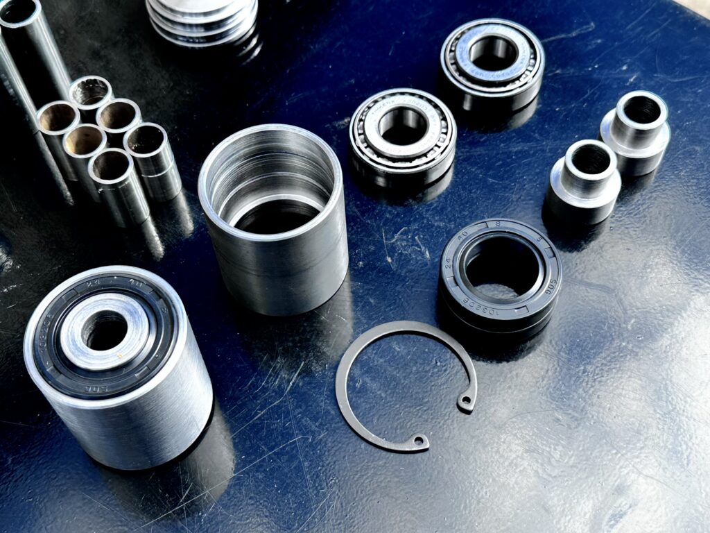 V2HO rocker-arm bearing assembly components including housings, bearings, seals and retainers