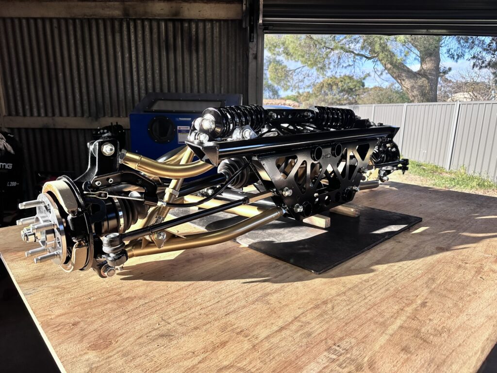 Completed Xdrift V2HO rear suspension assembly with gold powder-coated control arms
