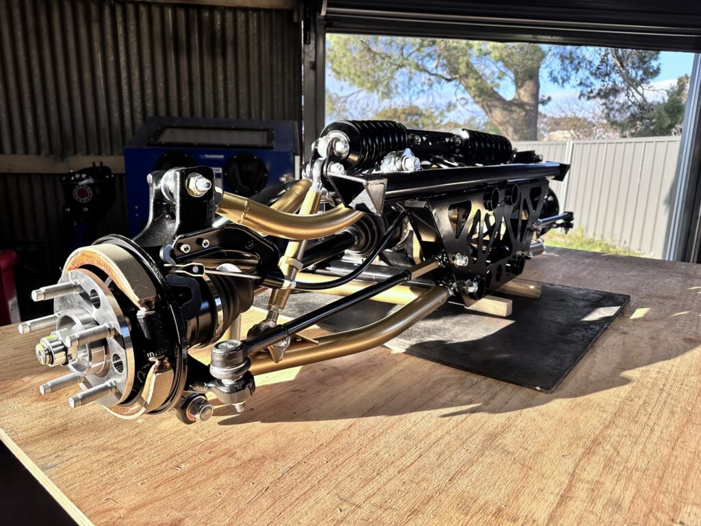 Completed Xdrift V2HO rear suspension assembly with gold powder-coated control arms
